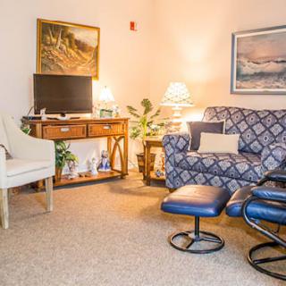 A cozy living room with comfortable furniture, a television, and tasteful decor.