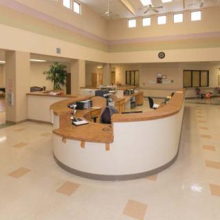 A spacious and well-lit reception area with a central desk.