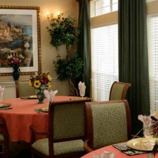 A cozy dining room with elegantly set tables and warm decor.