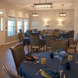 A well-decorated dining room with elegantly set tables and comfortable chairs.