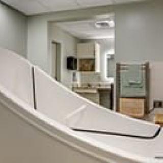 A modern bathroom in a healthcare facility featuring a specialized bathtub.