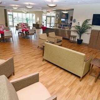 A spacious and modern lounge area with comfortable seating, a television, and ample natural light.