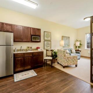 A cozy open-concept apartment with a kitchen and living area.