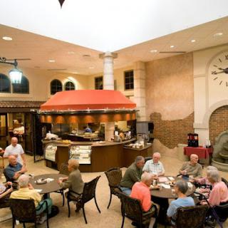 A cozy dining area filled with senior citizens enjoying a meal together.