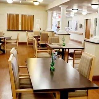An empty dining area with neatly arranged tables and chairs.