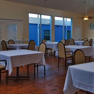An empty dining room with tables and chairs neatly arranged.
