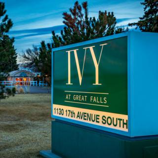 Sign for Ivy at Great Falls displaying address on a landscaped property.
