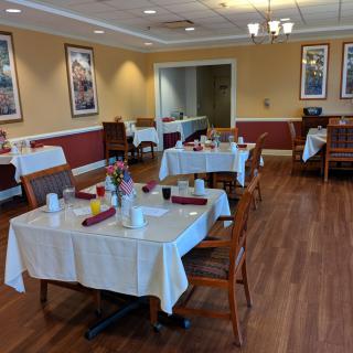 A neatly arranged dining area with tables set for service in a cozy restaurant.