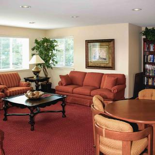 A cozy living room with comfortable sofas, a coffee table, and warm decor.