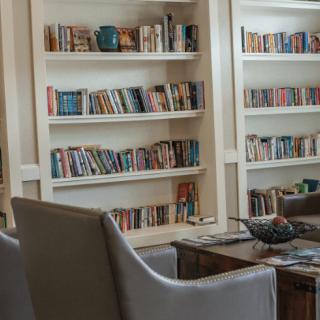 A cozy reading area with bookshelves and comfortable chairs.