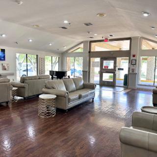 A spacious and welcoming lounge area featuring modern furniture and ample natural light.