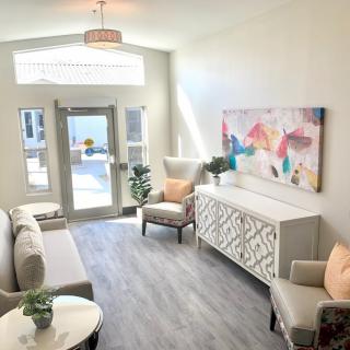 A modern and bright living room with stylish furniture and colorful artwork.