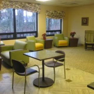A cozy waiting room with comfortable seating and large windows.