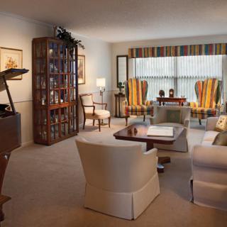 A cozy living room with elegant furniture and warm lighting.