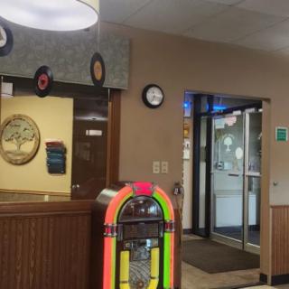 A retro-themed diner interior featuring a colorful jukebox near the entrance.