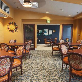 An inviting cafe interior with well-arranged tables and chairs, enhanced by warm lighting and decor.