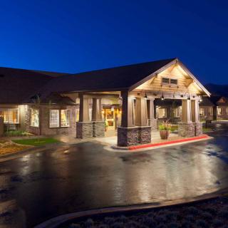 A warmly lit building at night with an inviting entrance.