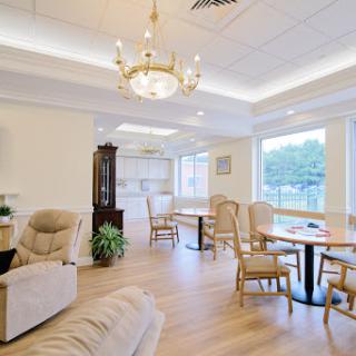 A cozy and inviting living space featuring a dining area, comfortable furniture, and ample natural light.