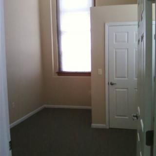 Small empty room with a window and door.