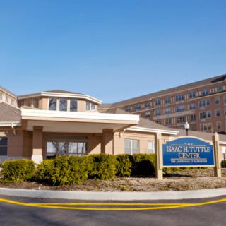 A hotel building with a clear blue sky background.