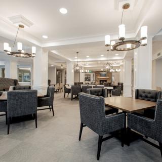 A modern dining area with stylish lighting and comfortable seating.