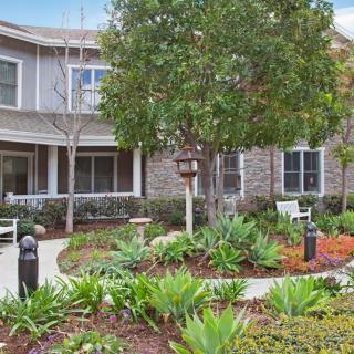 A beautifully landscaped garden in front of a residential building.
