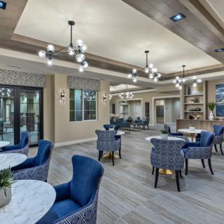 A modern lounge area with elegant seating and chandeliers.