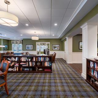 A well-lit library interior with bookshelves and seating areas.