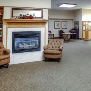 A cozy lobby area featuring a fireplace and comfortable armchairs.
