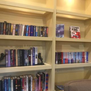 A cozy bookshelf filled with a variety of books, perfect for any reading enthusiast.