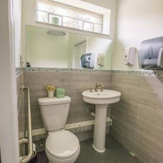 A modern and clean bathroom featuring a toilet and sink.