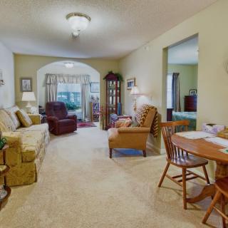 A cozy living room with comfortable seating and warm lighting.