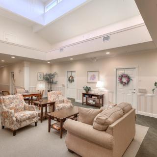 A cozy living room with comfortable sofas, a coffee table, and bright natural lighting.