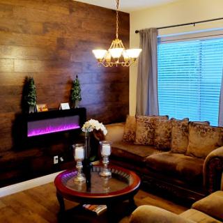 A beautifully designed living room featuring warm wood accents and cozy seating.