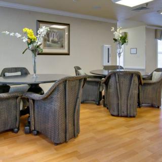 A well-arranged dining area with tables, chairs, and floral decorations.