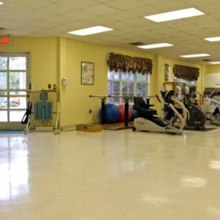 An indoor gym with exercise equipment and workout spaces.