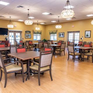 A spacious dining room with wooden tables and chairs, designed for comfort and social gatherings.