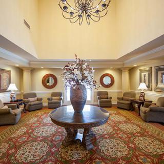 Elegant lobby with a central table and cozy seating arrangement.