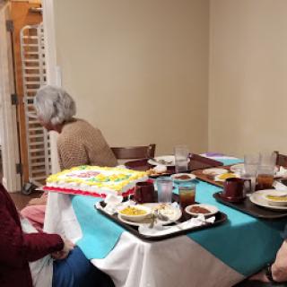 A cozy gathering around a table filled with delicious food.