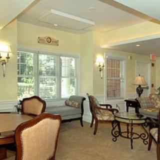 A cozy living room with elegant furniture and ample natural light through the windows.