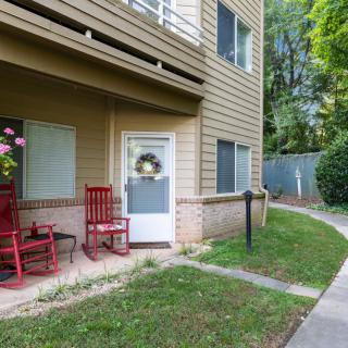 A cozy apartment entrance with red chairs and a decorative wreath on the door.