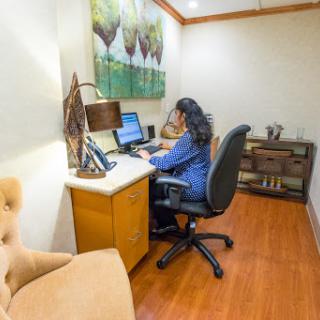 A woman working at her desk in a modern office environment.
