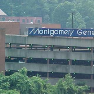 A view of the Montgomery General Hospital parking structure surrounded by trees.