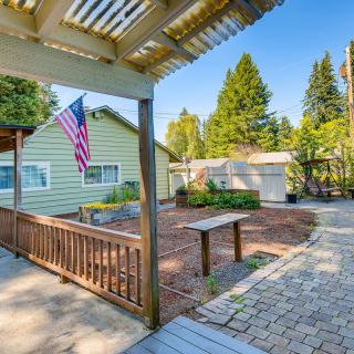 A sunny backyard with a patio, garden area, and an American flag.