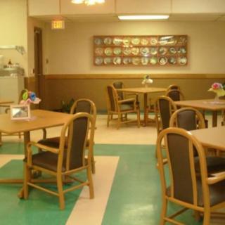 An empty dining area with neatly arranged tables and chairs.