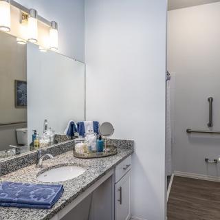A modern bathroom with a granite countertop and stylish decor.