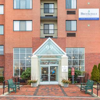 Entrance to a hotel with visible signage and symmetrical architectural design.