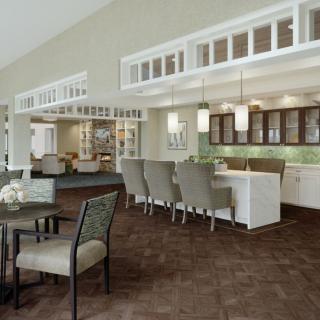 A modern open-plan kitchen and dining area with sleek furnishings.