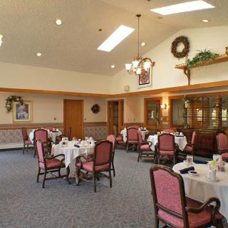 An elegant dining room with neatly arranged tables and chairs, ready for guests.