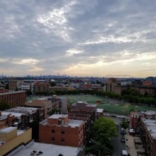 A panoramic view of the city skyline under a cloudy sky.